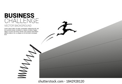 Silhouette of businesswoman jump across the wall with springboard. Concept of boost and move forward in business.