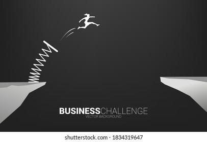 Silhouette of businesswoman jump over the gap with springboard. Concept of boost and growth in business.