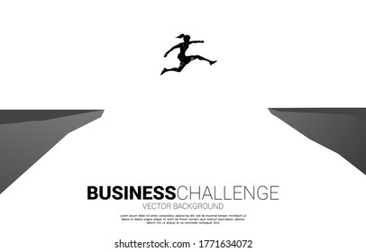 silhouette of businesswoman jumping over the gap of valley. concept of business challenge risk.