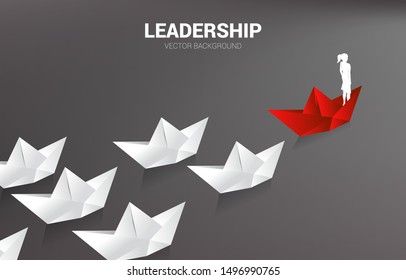 Silhouette of businesswoman on red origami paper ship leading the white. Business Concept of leadership and vision mission.