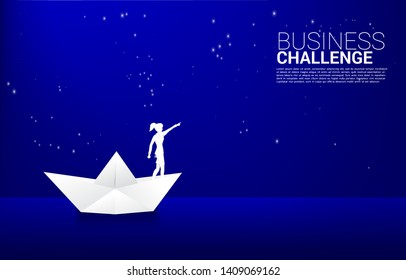 silhouette of businesswoman in paper ship origami point to star in the sky at night. Concept of route to success. Goal Mission Vision success in career path.