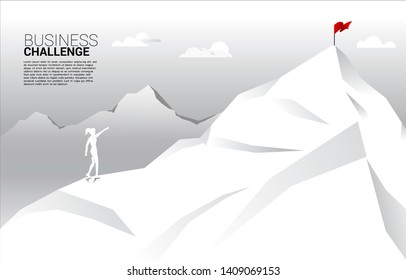 silhouette of businesswoman point to flag at top of mountain. Concept of route to success. Goal Mission Vision success in career path.