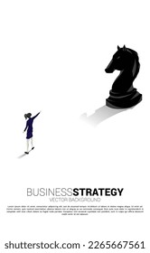 Silhouette of businesswoman  point forward with chess piece. concept of business strategy marketing.