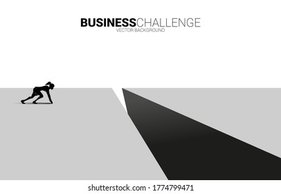 silhouette of businesswoman ready to run to jumping over the gap. concept of business challenge risk.