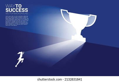 Silhouette businesswoman running in light from exit door shape trophy. Business Concept of route to winner and champion