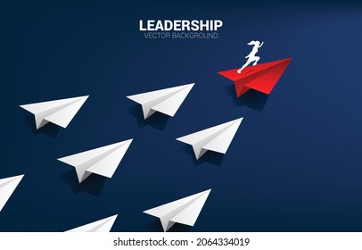 Silhouette of businesswoman running on red origami paper airplane leading group of white. Business Concept of leadership and vision mission.