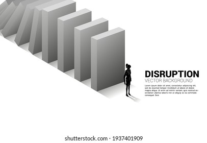 Silhouette of businesswoman standing at the end of domino collapse. Concept of business industry disrupt 