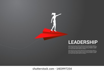 silhouette of businesswoman standing on red origami paper airplane. Business Concept of leadership, start business and entrepreneur