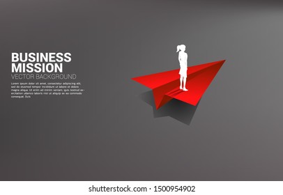 silhouette of businesswoman standing on red origami paper airplane. Business Concept of leadership, start business and entrepreneur