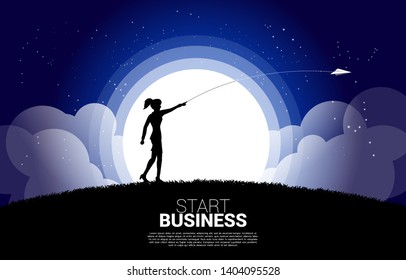 silhouette of businesswoman throw out origami paper airplane at night. Business Concept of start business and entrepreneur