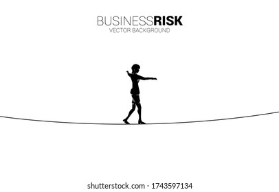 Silhouette of businesswoman walking on rope walk way.Concept for business risk and challenge in career path
