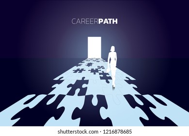 Silhouette of businesswomen with briefcase standing on road to the door from jigsaw piece. business concept of make you own way. 