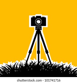 Silhouette of camera on orange background