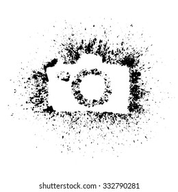 Silhouette of a camera painted using ink splashing. Isolated. Vector illustration. 