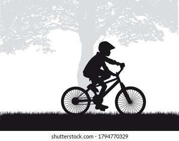 Silhouette of a child on a bike.