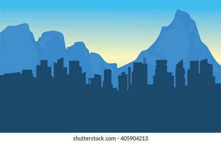 Silhouette of city and background mountain at sunset