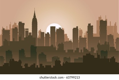 Silhouette of the city at night against the setting sun