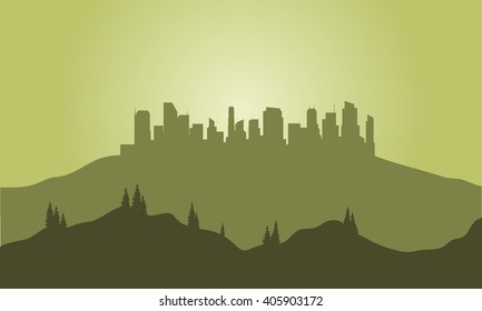 Silhouette of city on the hills with green background