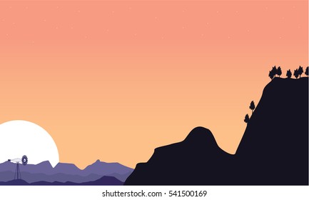 Silhouette of cliff and windmill scenery