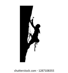 silhouette of a climber hammering a hook on a rock