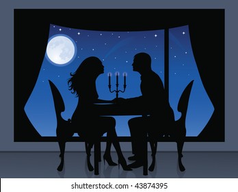 Silhouette of a couple having a romantic evening. On the background a view from window of full moon and stars.