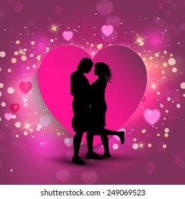 Silhouette of a couple kissing on a heart background