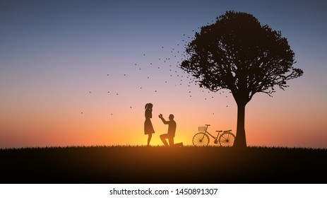 silhouette couple man down on knee proposing to woman under trees with sunset sky background