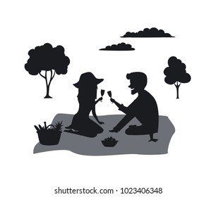 silhouette of a couple on a picnic in the park