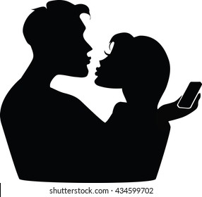 Silhouette of a couple with phones.