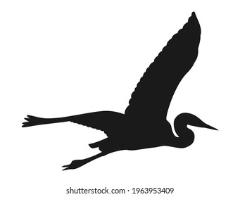 Silhouette of a crane flying open its wings