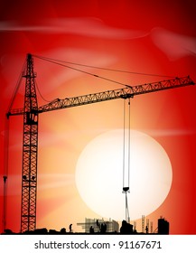 Silhouette of crane on a sunset on building