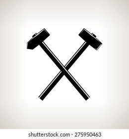 Silhouette of a crossed hammer and sledgehammer on a light background, hand tool with a hard head attached perpendicular to the handle ,black and white vector illustration