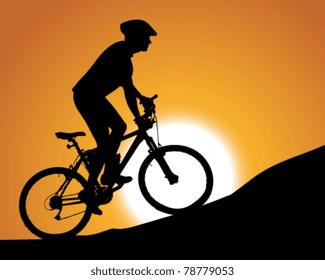 silhouette of a cyclist with sunset background