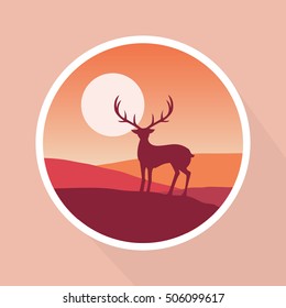 Silhouette of deer on a mountain peak against sunset landscape.