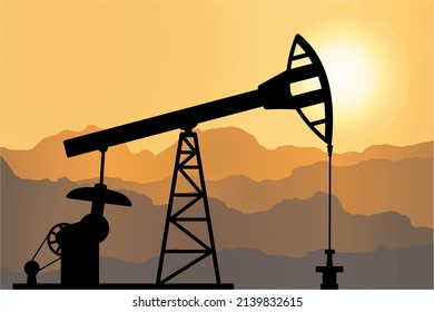 Silhouette of a derrick on a mountainous background 