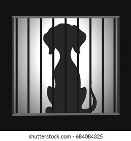 Silhouette of a dog in a cage.