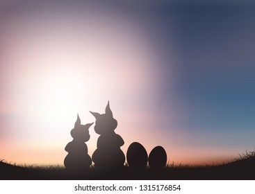 Silhouette of Easter bunnies against a sunset sky