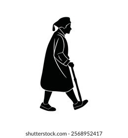 Silhouette of an elderly person in graduation gown walking with a cane.