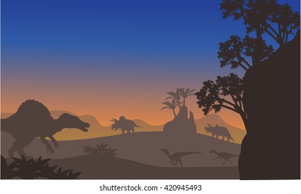 Silhouette of eoraptor and spinosaurus at the afternooon