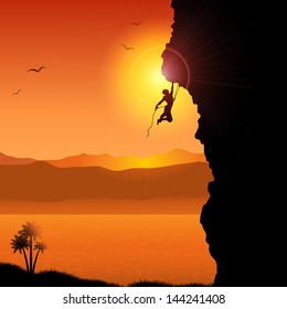 Silhouette of an extreme rock climber against a tropical landscape