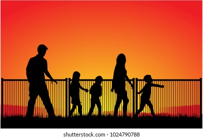 Silhouette of family at sunset .