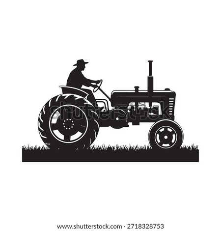 Silhouette of a farmer driving an old fashioned tractor through a field
