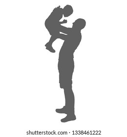 Silhouette father and child. A man stands and raises the boy in his arms.