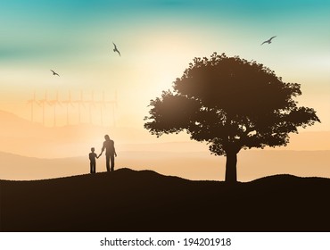 Silhouette of a father and son walking in the countryside