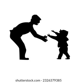silhouette of a father teaching his infant son to walk
