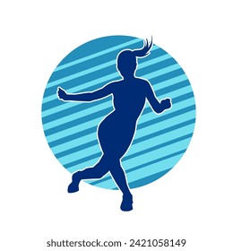 Silhouette of a female dancer in action pose. Silhouette of a slim woman in dancing pose.