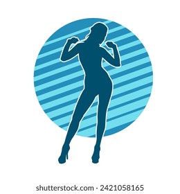 Silhouette of a female dancer in action pose. Silhouette of a slim woman in dancing pose.