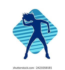 Silhouette of a female dancer in action pose. Silhouette of a slim woman in dancing pose.