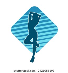 Silhouette of a female dancer in action pose. Silhouette of a slim woman in dancing pose.