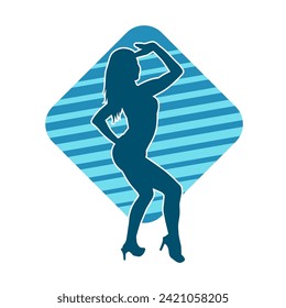 Silhouette of a female dancer in action pose. Silhouette of a slim woman in dancing pose.